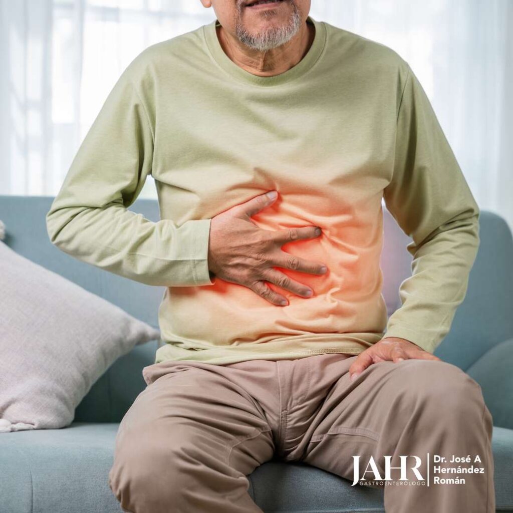 Hombre en el sofá con dolor abdominal